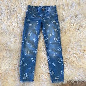 Blue denim jeans with white hearts